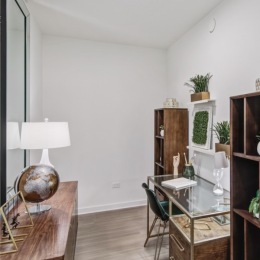 den area with desk bookshelves and tables